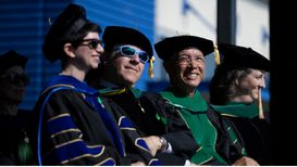 Faculty Recognition - Four individuals in academic regalia
